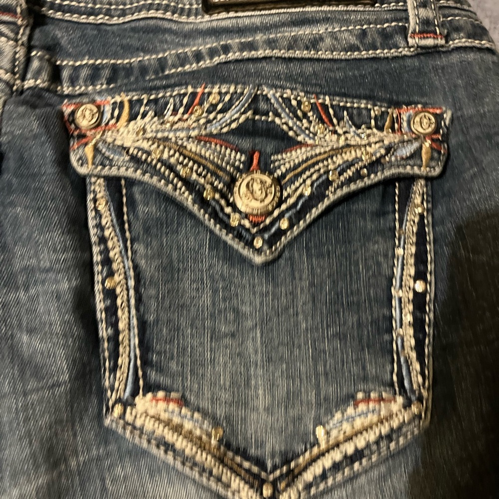 Grace in LA Blue Jeans with Intricate Embellishments